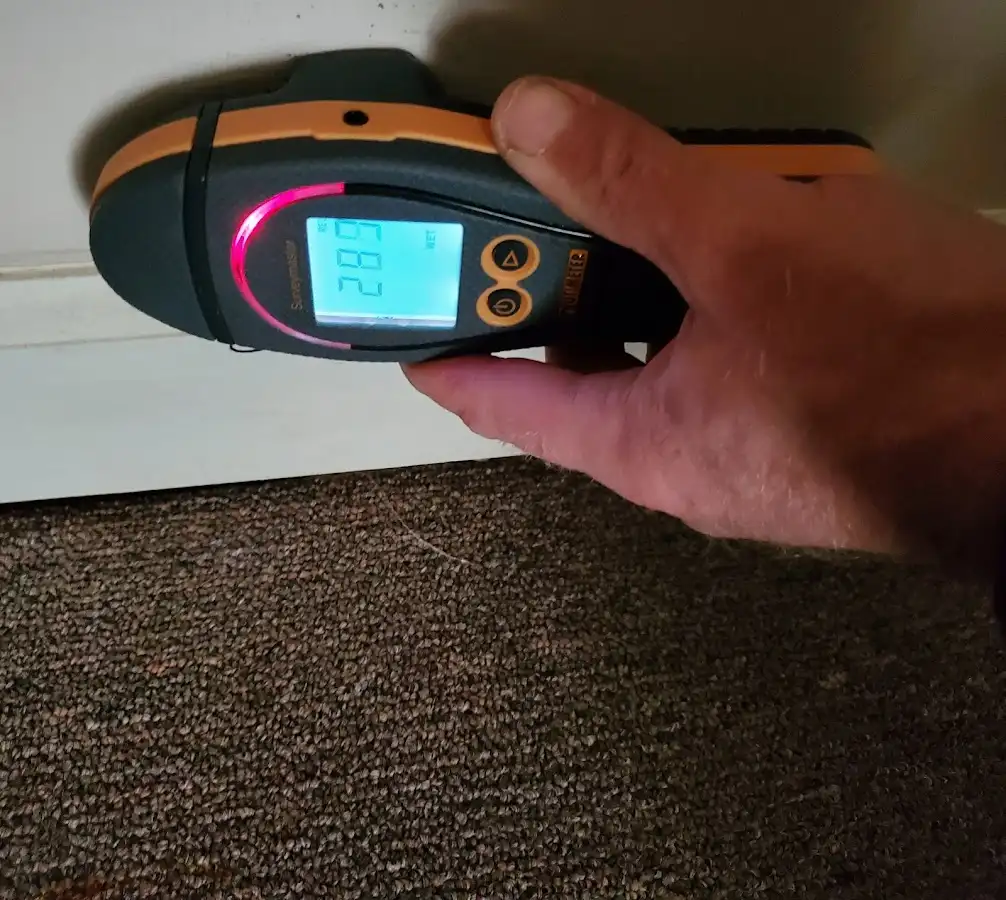 Moisture detection at baseboard during Storm Damage Restoration in Sun City